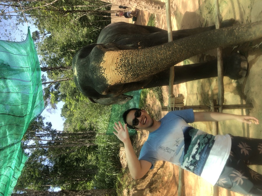 Chae waving next to an elephant in Phuket